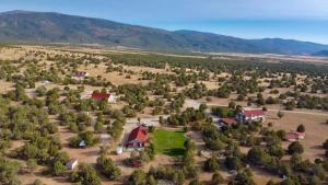 an aerial view of a farm with trees and houses at The Joseph Studio at Wind Walker Homestead in Spring City