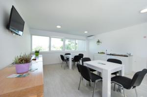 a meeting room with tables and chairs and a tv at Hotel Potpican in Potpićan +24 photos