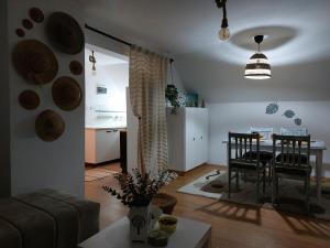 a living room with a table and a dining room at Apartman Vrganj in Savinac