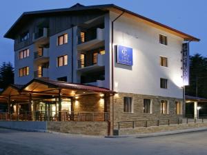 a building with a sign on the side of it at The Lodge Hotel in Borovets