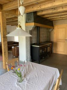 a dining room table with a vase of flowers on it at Brasel in La Brévine