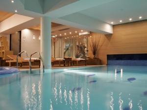 a swimming pool in a hotel with a restaurant at The Lodge Hotel in Borovets