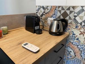 B&b Principe18 في نوتشي: آلة صنع القهوة وماكينة صنع القهوة على منضدة خشبية