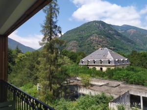 a view of a building with a mountain in the background at Chez Marie-Laure, T3 résidence les Jardins de Ramel, parking, balcon, 4 personnes in Luchon