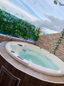 a large bath tub sitting on top of a building at Romantic Studio w/Jacuzzi 15 min Airport in Ensanche Los Minas