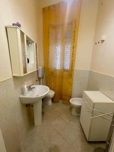 a bathroom with a sink and a toilet at A Casa di Mau in Palermo
