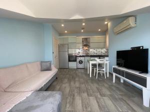 a living room with a couch and a kitchen at X SUITE APART in Fethiye