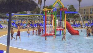 a group of people playing in a water park at TrendyHomes El Puerto de Almería, próximo Playa y Centro,3 HAB, Espacioso, Familias, Wifi in Almería