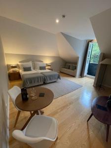 a large bedroom with a bed and a table and a table sidx sidx at PIER HOUSE Accommodation in Funchal