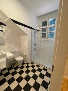 a bathroom with a toilet and a walk in shower at PIER HOUSE Accommodation in Funchal