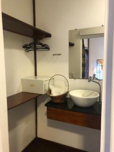 a bathroom with a sink and a mirror at Palma Hostel in São Luís