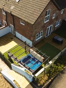 an overhead view of a swimming pool in front of a house at Clwyd Cottage - Two Bed, Barn Conversion with Private Hot Tub in Bodfari