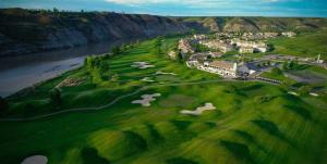 an aerial view of a golf course next to the water at Paradise Canyon Golf Resort, Luxury Condo M407 in Lethbridge