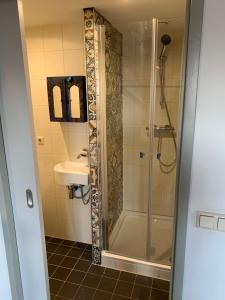 a bathroom with a shower and a sink at 't Brouwershuis in Leende