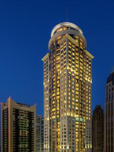 a tall building with a dome on top of it at Dusit Hotel & Suites - Doha in Doha