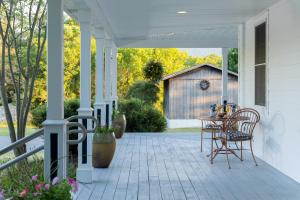 a porch with a table and a barn at Apple Pony Inn in Boalsburg