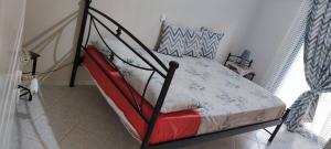 a bedroom with a bed with a metal frame at TAVARI HOUSE 1 in Tavari