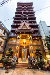 a tall building with a statue in front of it at Okay Boutique Hotel in Phnom Penh