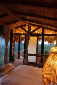 a bedroom with a bed in a room with a view at Eco Hotel Glamping El Silencio in Santa Rosa de Cabal