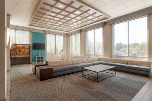 a large living room with a couch and a table at Holiday Inn Boston Bunker Hill Area, an IHG Hotel in Somerville