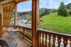 a view from a deck with a table and chairs at Perle de savoie - Apt C706 - BO Immobilier - Châtel -remises sur les forfaits de skis Châtel ou Portes du soleil in Châtel