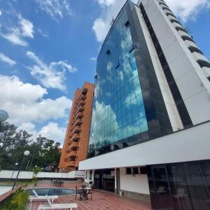 a tall glass building with a pool in front of it at Executive suite in gastronomic district in Valencia