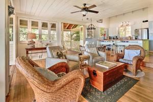 a living room with chairs and a table at Tropical Paniolo Hale Townhome, Walk to Beach in Maunaloa