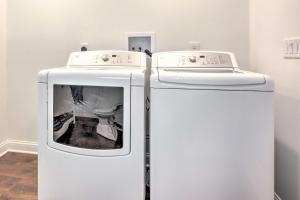 two white refrigerators in a room with a toilet at Cascade Lakefront Home Boat Dock, Fire Pit! in Cascade