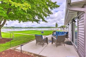 a patio with chairs and a table with a view of the water at Cascade Lakefront Home Boat Dock, Fire Pit! in Cascade