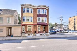 a building on the corner of a street with cars parked at Pet-Friendly Allentown Retreat with Backyard! in Allentown