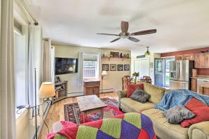 a living room with a couch and a ceiling fan at Sunny Morristown Home - Walk to Restaurants! in Morristown