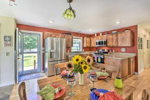 a kitchen with a table with sunflowers on it at Sunny Morristown Home - Walk to Restaurants! in Morristown