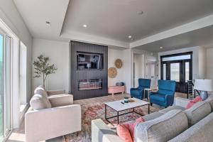 a living room with a couch and chairs and a fireplace at Picturesque Moses Lake House with Boating Dock in Moses Lake
