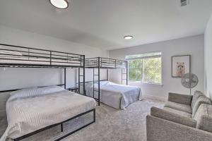 a bedroom with two bunk beds and a couch at Picturesque Moses Lake House with Boating Dock in Moses Lake