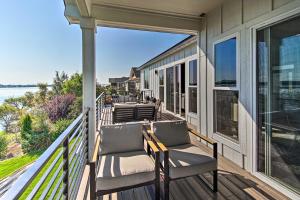 a porch with two chairs and a view of the water at Picturesque Moses Lake House with Boating Dock in Moses Lake