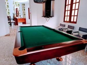 a pool table in the middle of a living room at CerroAly in Santiago de los Caballeros