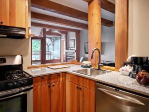 a kitchen with a sink and a stove at Beautiful Condo In A Great Location, Oceanfront Complex - Oe in Ucluelet