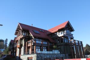 a large building with a red roof at Beautiful Condo In A Great Location, Oceanfront Complex - Oe in Ucluelet