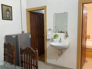 a bathroom with a sink and a refrigerator at R.H.S VILLA in Varanasi