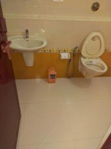 un baño con inodoro y lavabo en Horn Bill Cottage, en Thekkady