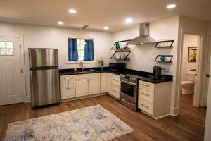 a kitchen with a stainless steel refrigerator and white cabinets at Mission Springs Resort in Ashland