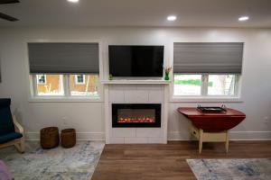 a living room with a fireplace and a tv at Mission Springs Resort in Ashland