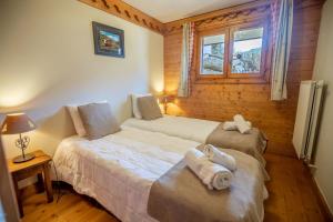 a bedroom with two beds with towels on them at Daguet 1D6 in Les Allues +3 photos