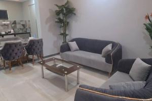 a living room with a couch and a table at RK island view 3 bedroom apartment in Dabolim