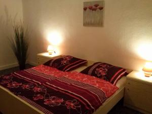 a bedroom with a bed with two pillows on it at Apartment 1 Langelsheim Harz in Langelsheim
