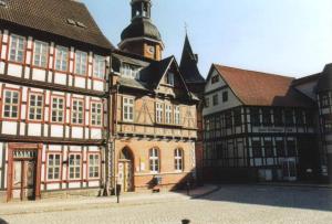 an old building with a clock tower in a town at Apartment 1 Langelsheim Harz in Langelsheim
