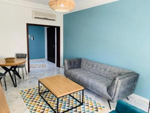 a living room with a couch and a table at The Perfect Flat, Lac 2, Tunis in Tunis