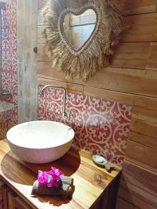 a bathroom with a sink and a mirror on a counter at villa gilimakyah in Gili Air