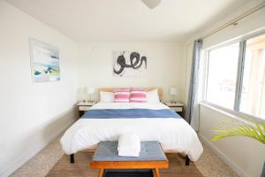 a bedroom with a large bed and a table at Casa Limonada Boutique Motel in Sarasota