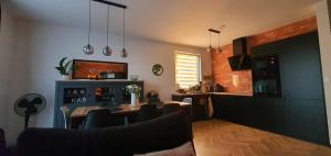 a kitchen and dining room with a table and chairs at Czarne Nad Białym in Gostynin